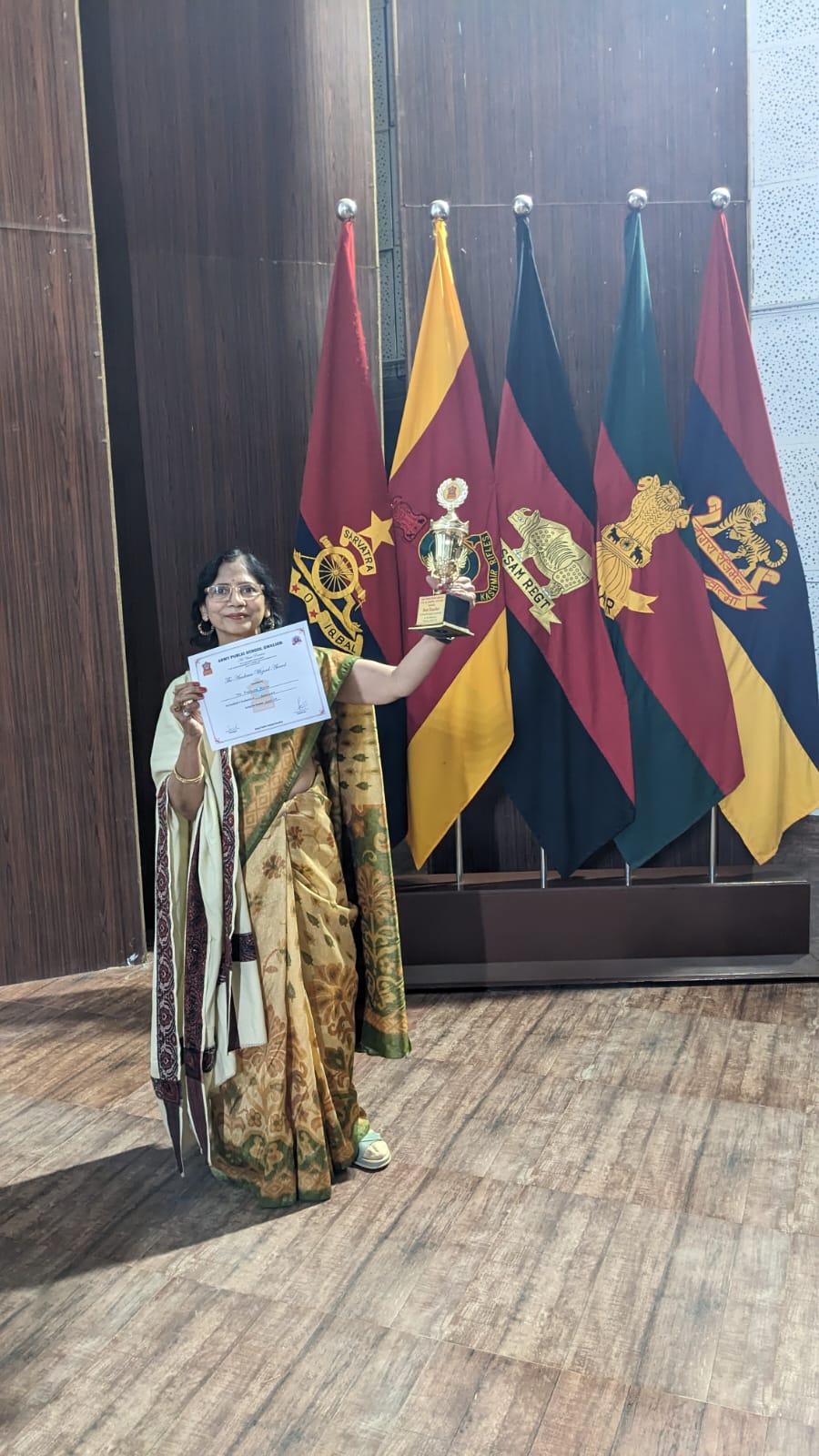 Padmaja Gupta holding a trophy and certificate